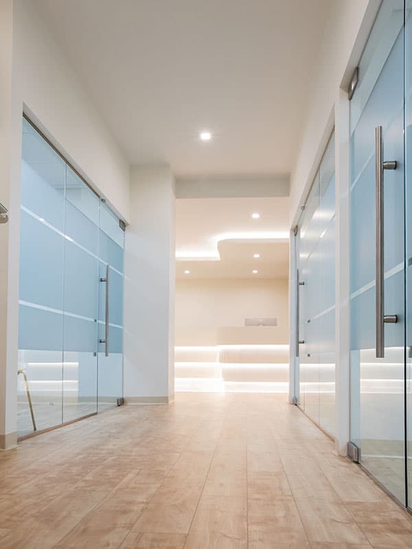 hallway with glass doors and walls