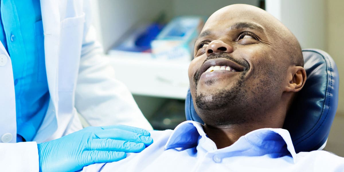 man in dental chair smiling